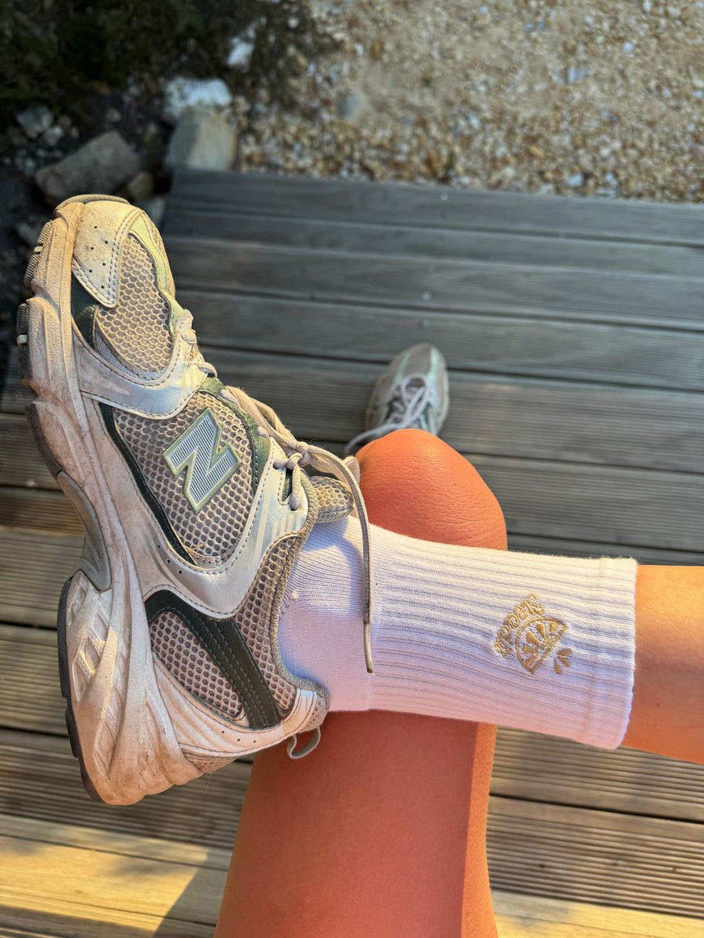 Premium Reformer Pilates socks with lemon design trainers and decking and the sun pouring in